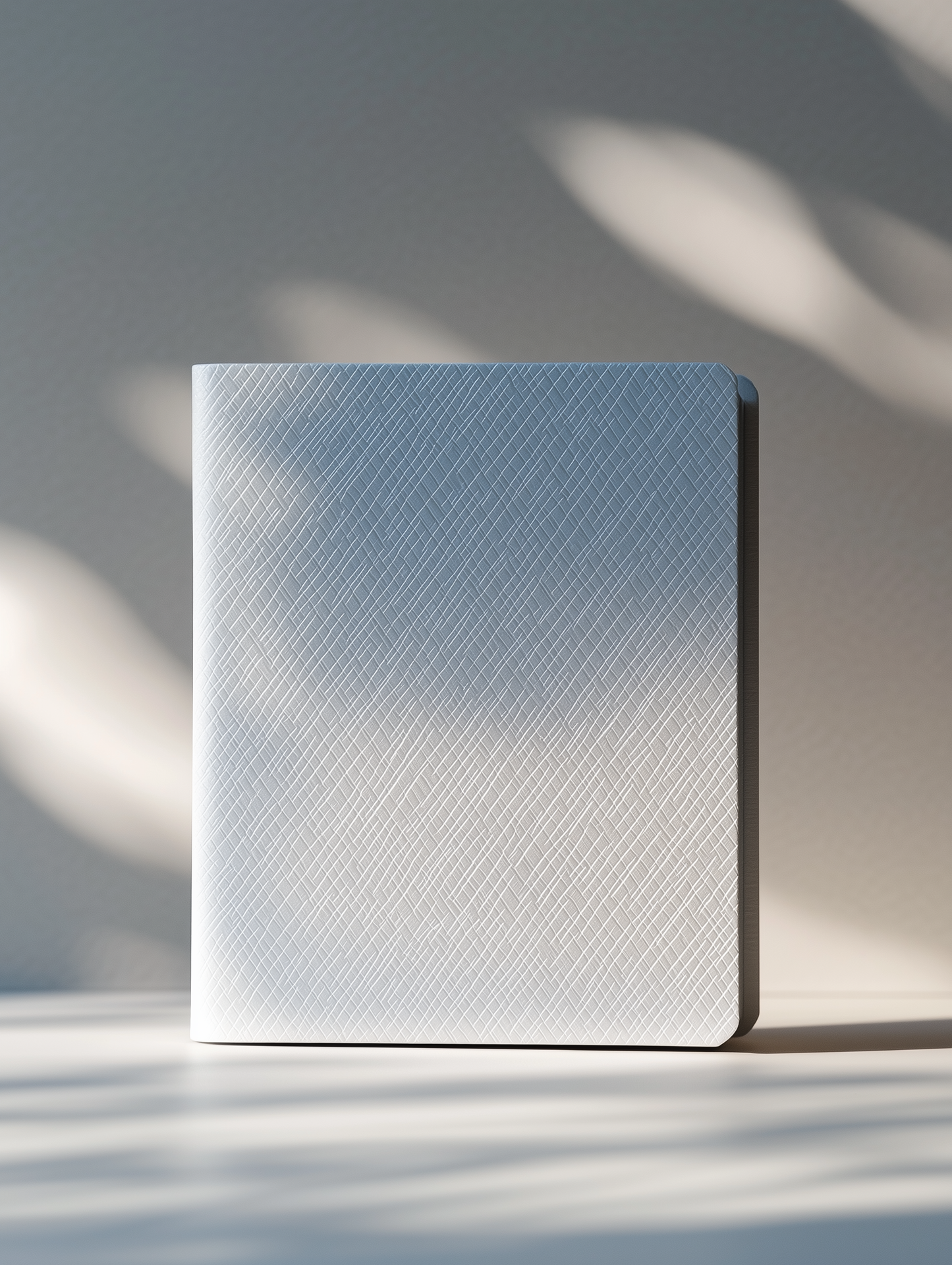 A pearl white hard-shell notebook with geometric diamond patterns and a soft glow finish, designed by Chloe Wei in collaboration with Conify. Displayed on a white pedestal with a minimalist background and soft light shadows, showcasing its high-fashion aesthetic.